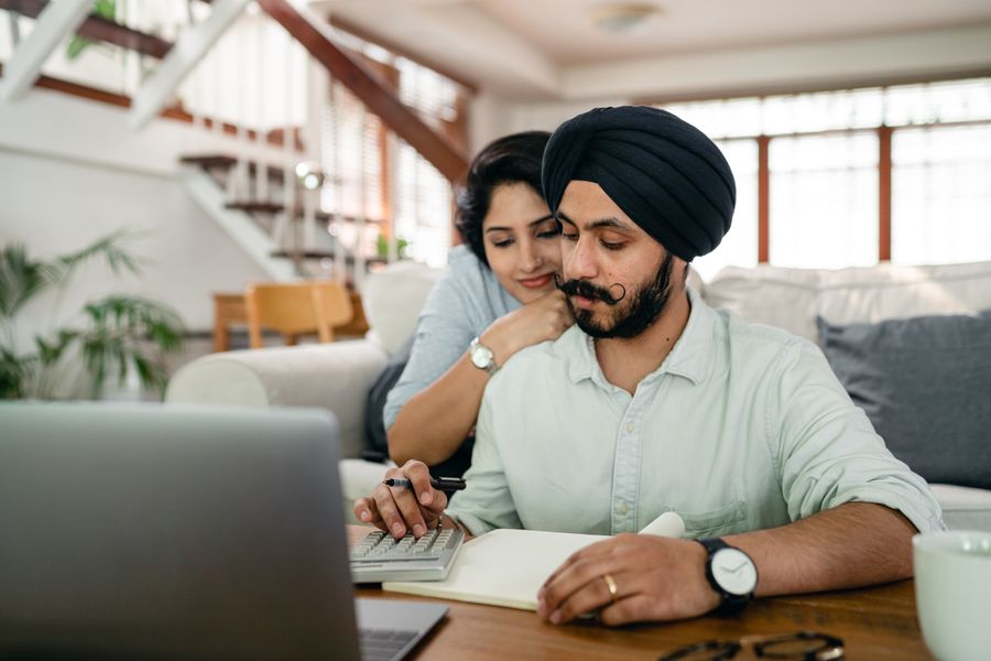 Couple working through their bills together at home